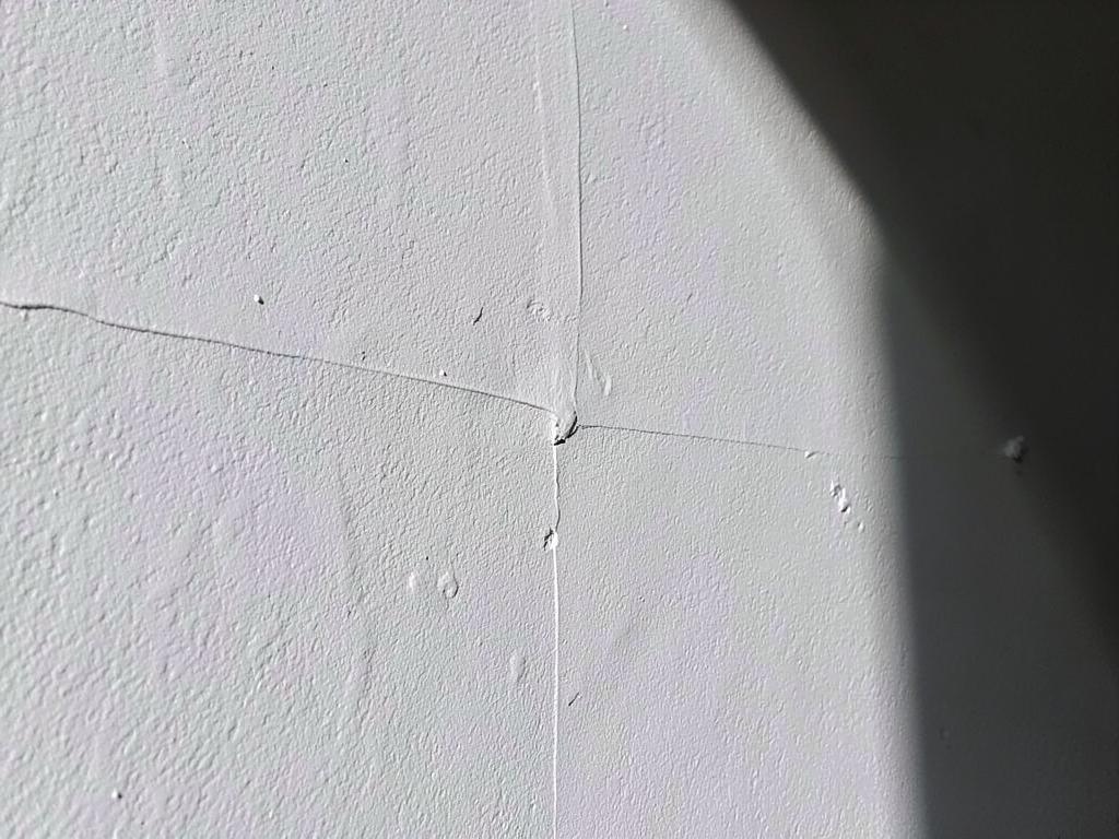 Standard drywall finish showing faint joints and fastener marks under raking light
